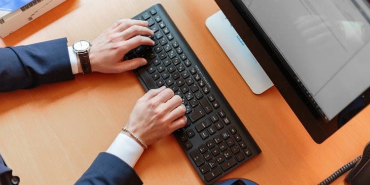 Person Typing on Computer Keyboard