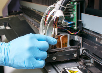 Man repairing a printer