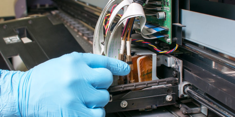 Man repairing a printer