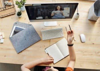 Top View Photo of Girl Watching Through Imac