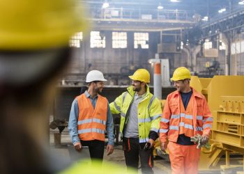 Workers walking and talking in factory