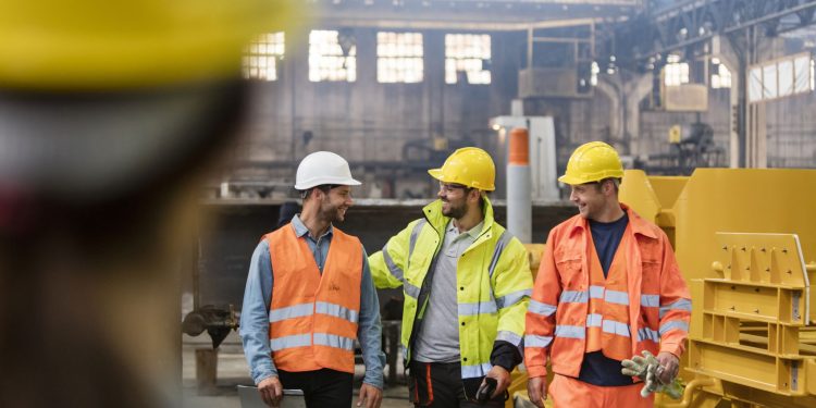 Workers walking and talking in factory