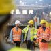 Workers walking and talking in factory